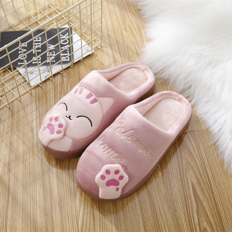 Women’s light pink cat slippers with plush lining and paw print accents, slip-on