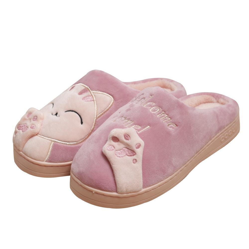 Women’s pale pink cat slippers with plush lining and “welcome home” text, slip-on