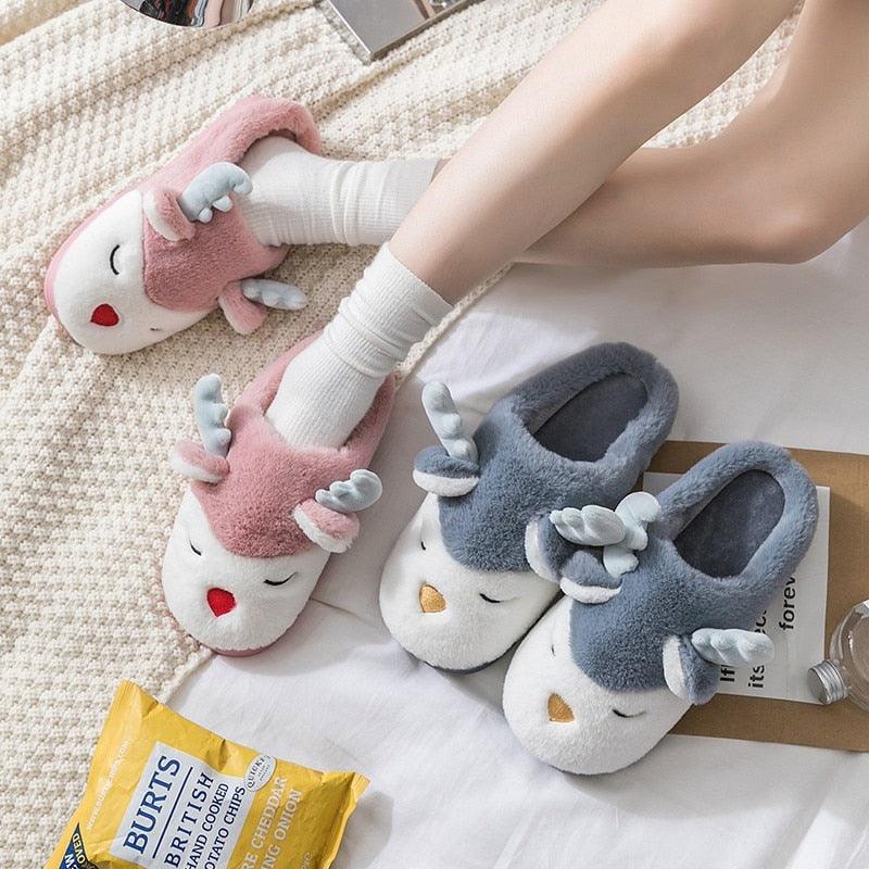 Pink, blue, and grey fuzzy slippers with animal faces and soft open-back design