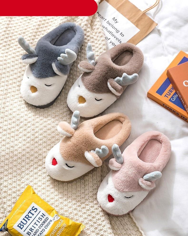 Assorted plush animal-face slippers in blue, tan, and pink with curled ear details
