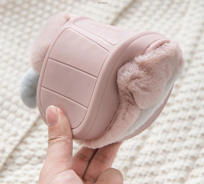 Pink plush slipper with soft fuzzy lining and textured non-slip outsole