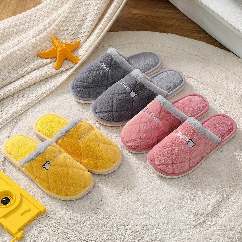 Plush house slippers in gray, pink, and yellow with cartoon accents and soft lining