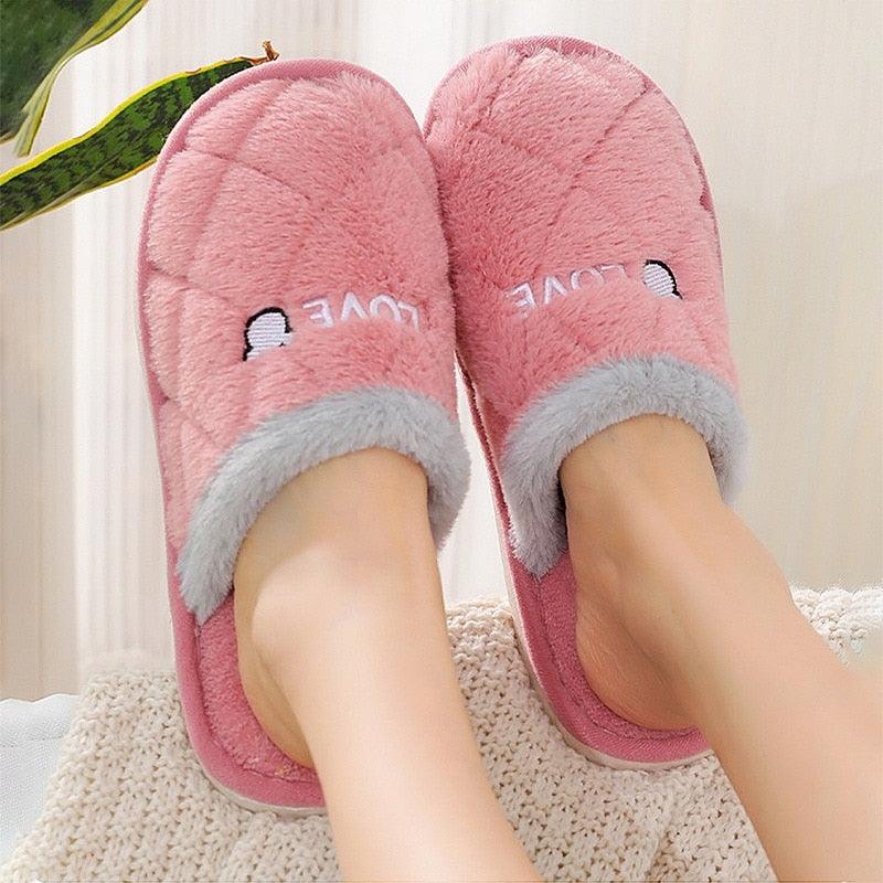 Pink plush slippers with white faux-fur trim and open slip-on style