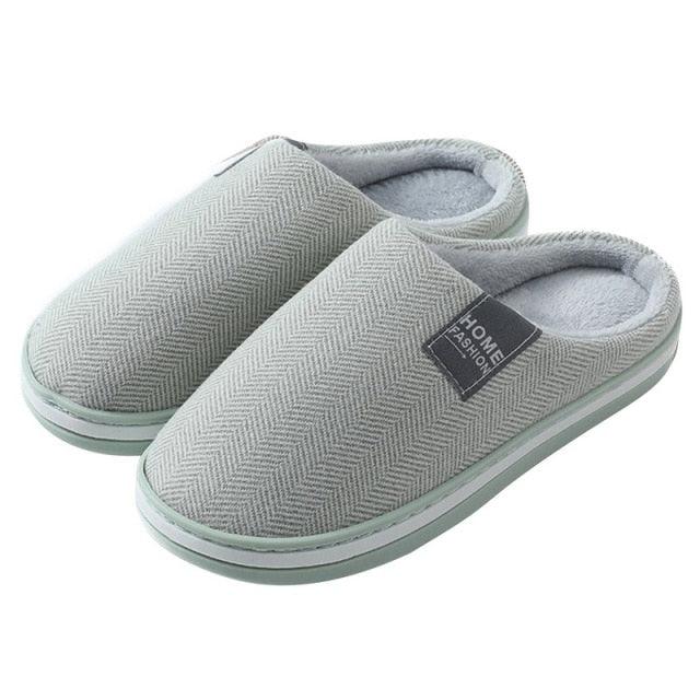 Grey slip-on slippers with textured knit upper and soft cushioned interior