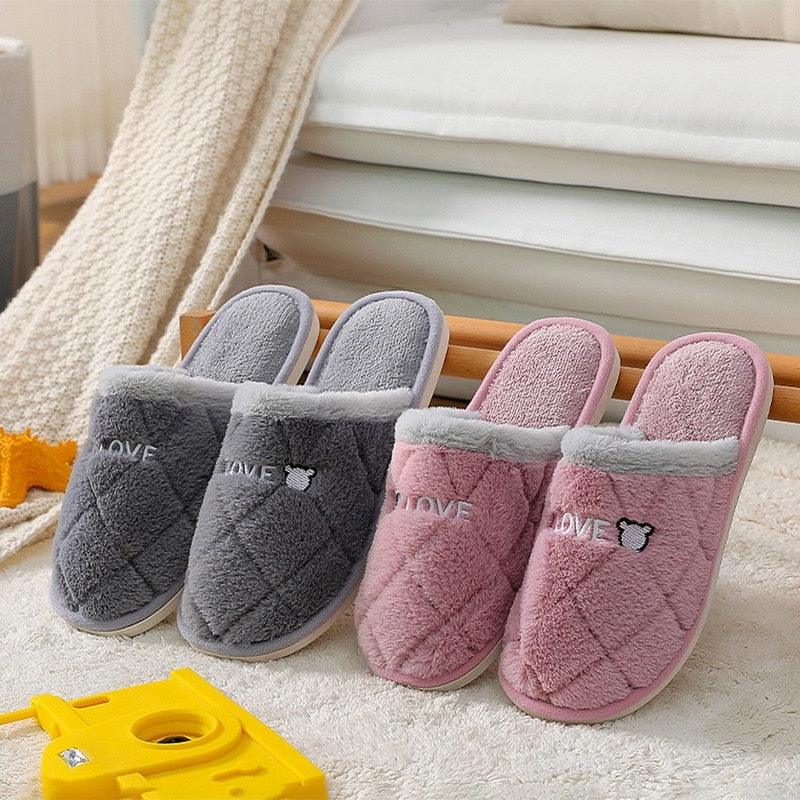 Set of plush grey and pink house slippers with bear graphic