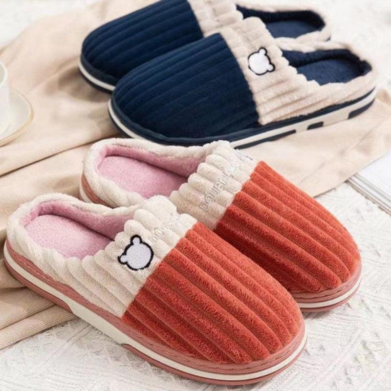Navy and orange plush house slippers with bear patch and textured knit