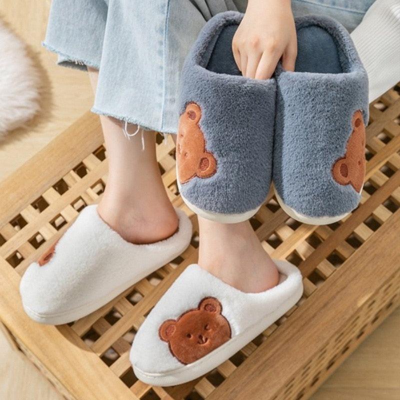 Gray plush slip-on slippers with brown bear appliques and cozy white fur trim