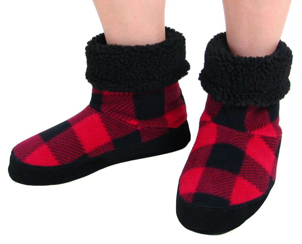 Women’s buffalo plaid snugs worn, showing red-black check uppers and black sherpa cuffs
