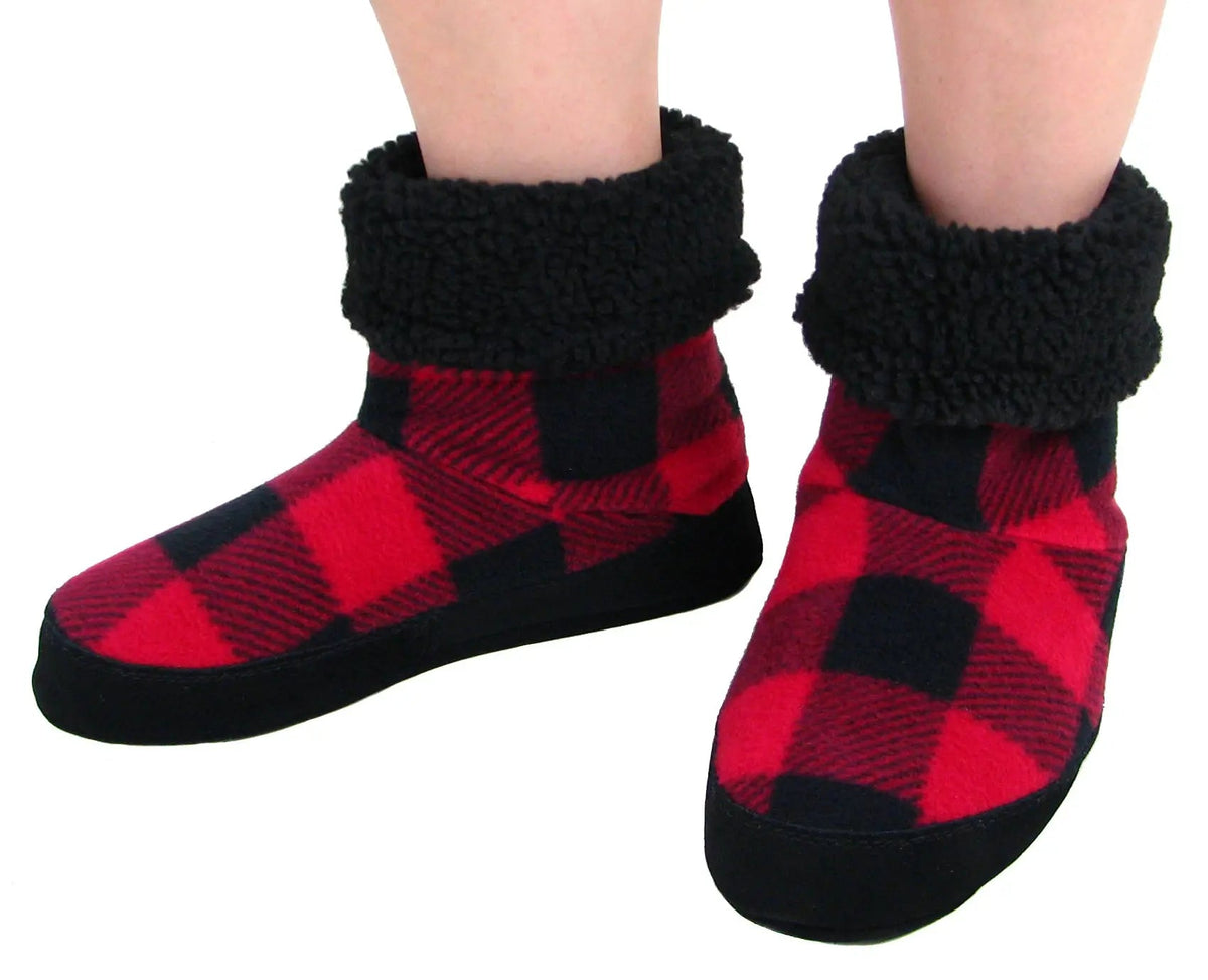 Women’s buffalo plaid snugs worn, showing red-black check uppers and black sherpa cuffs
