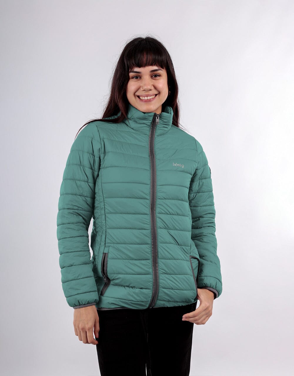 Women’s teal alpaca puffer jacket with hood and full-zip, worn by model