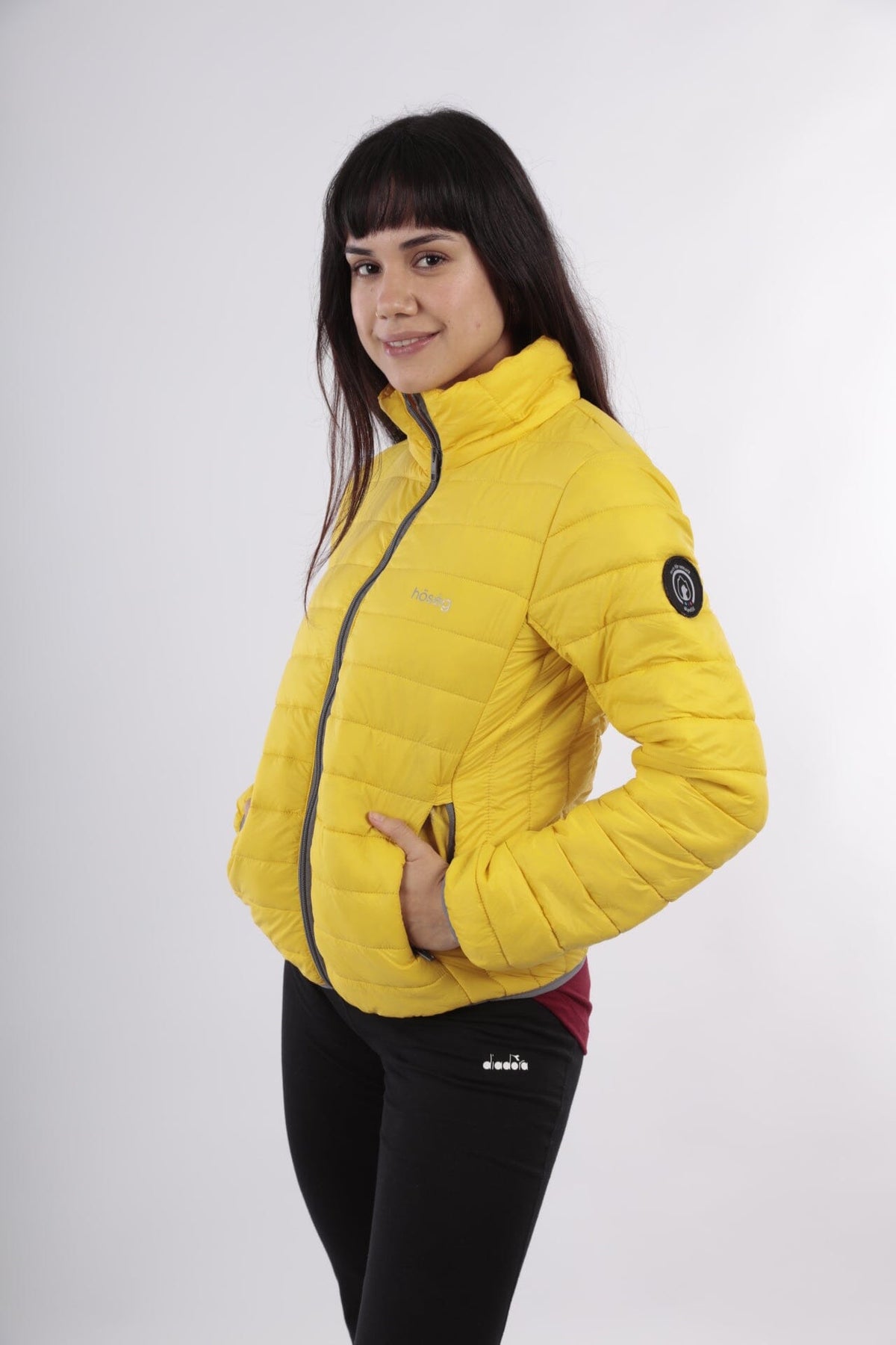 Yellow alpaca puffer jacket with hood, full-zip, and side patch detail