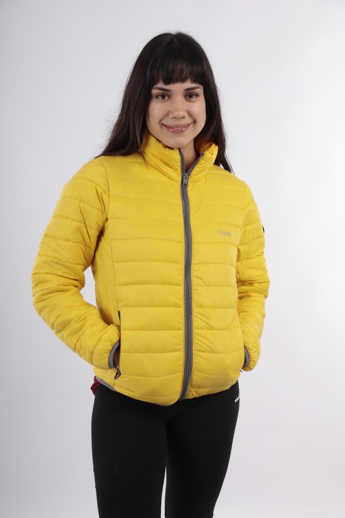 Women’s yellow alpaca puffer jacket with hood and full-zip, worn by model