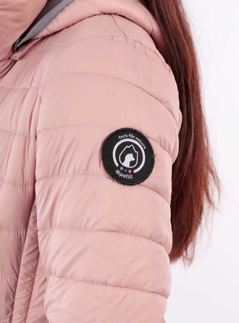 Mauve puffer jacket sleeve close-up with round Alpafill logo patch