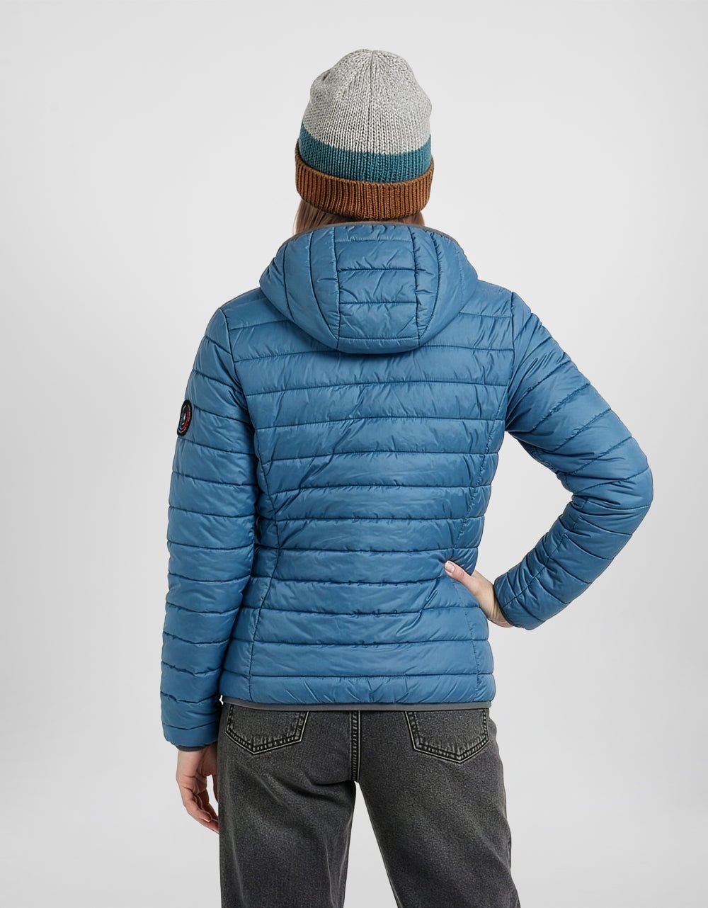 Women's blue alpaca puffer jacket from back with hood and long sleeves