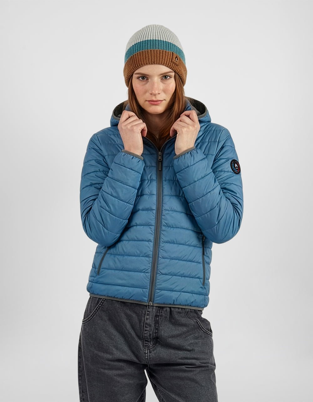 Women's blue alpaca puffer jacket with hood, full-zip front, long sleeves