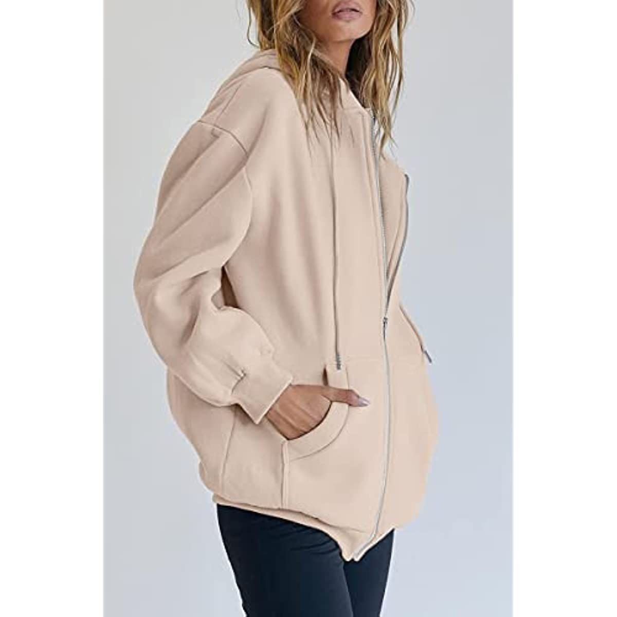 Beige oversized zip-up hoodie with hood and drawstring, side view