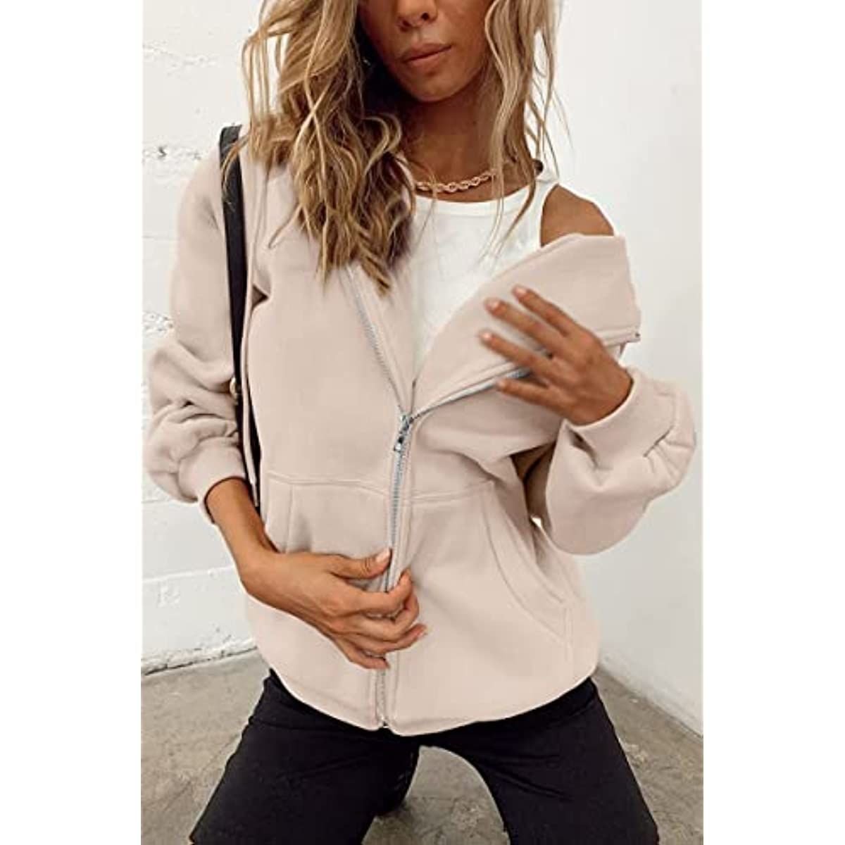 White zip-up hoodie with hood, front pockets, and ribbed cuffs