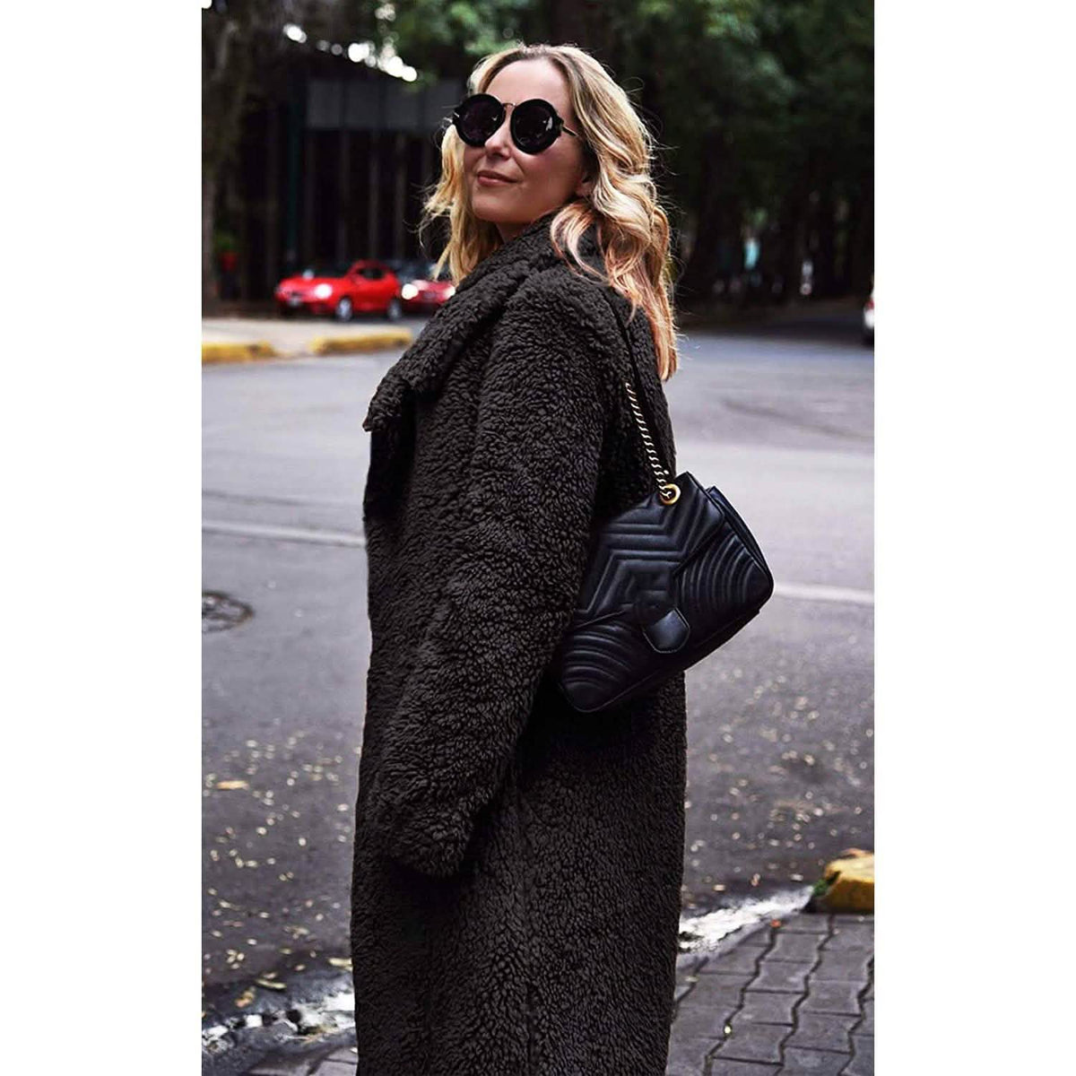 Black fuzzy fleece long cardigan coat with open front and lapels, side view