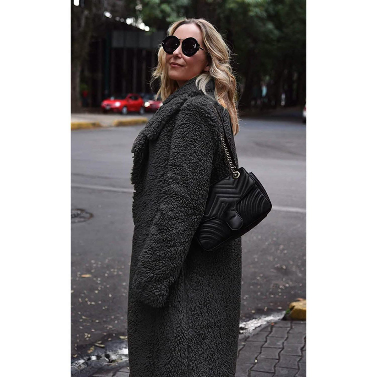 Black fuzzy fleece long cardigan coat with lapel and open front, side view