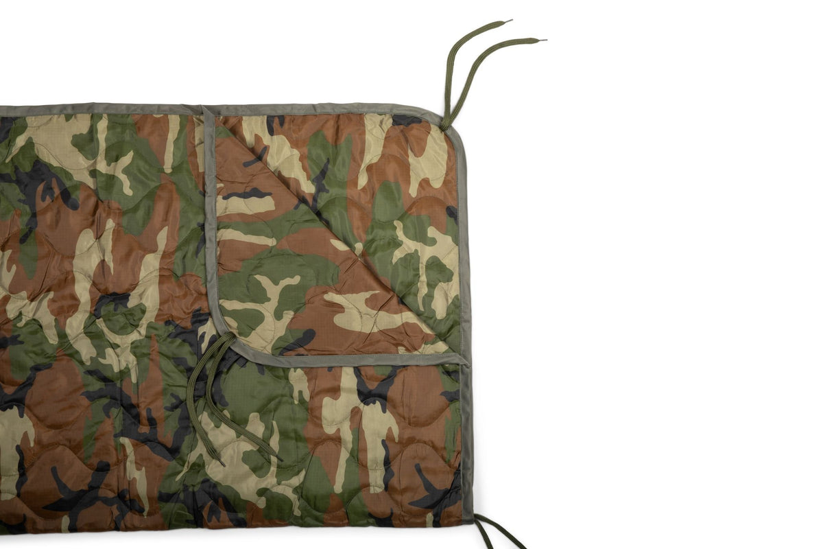 Woobie blanket in woodland camo, open panel view with drawstring cord at edge