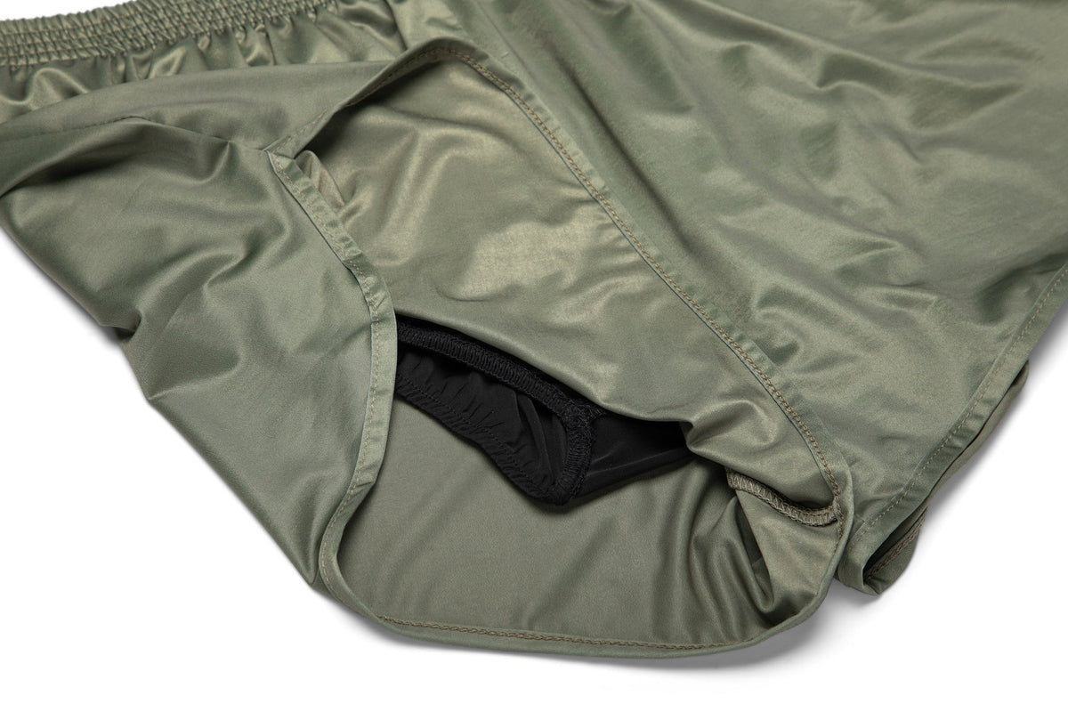 Olive-green athletic shorts with black inner panel and stitched hem