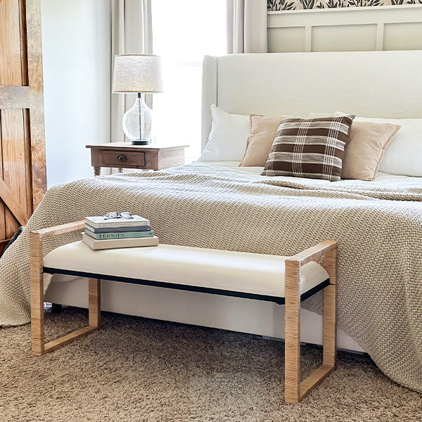 Woven rattan wooden bench with light wood frame and beige upholstered seat cushion
