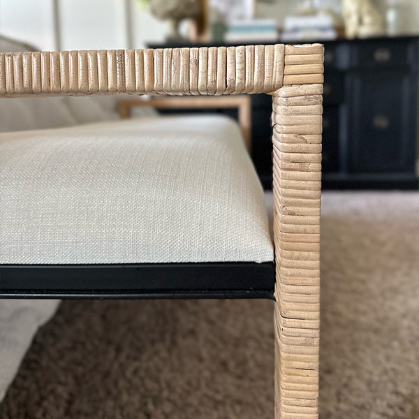 Woven rattan wooden bench arm corner with cream upholstery and natural wood finish