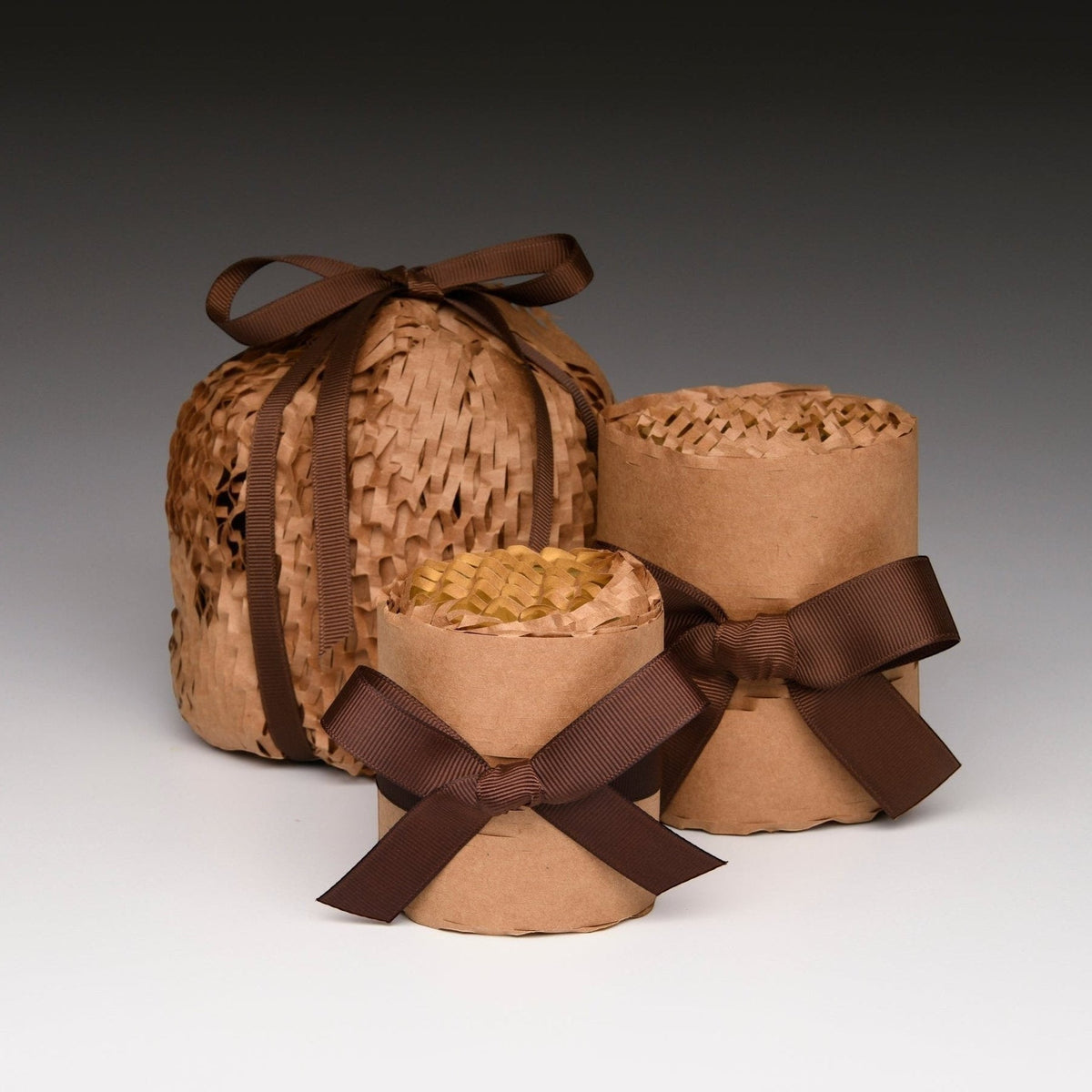 Kraft paper wrapped candle jars with brown ribbon bows