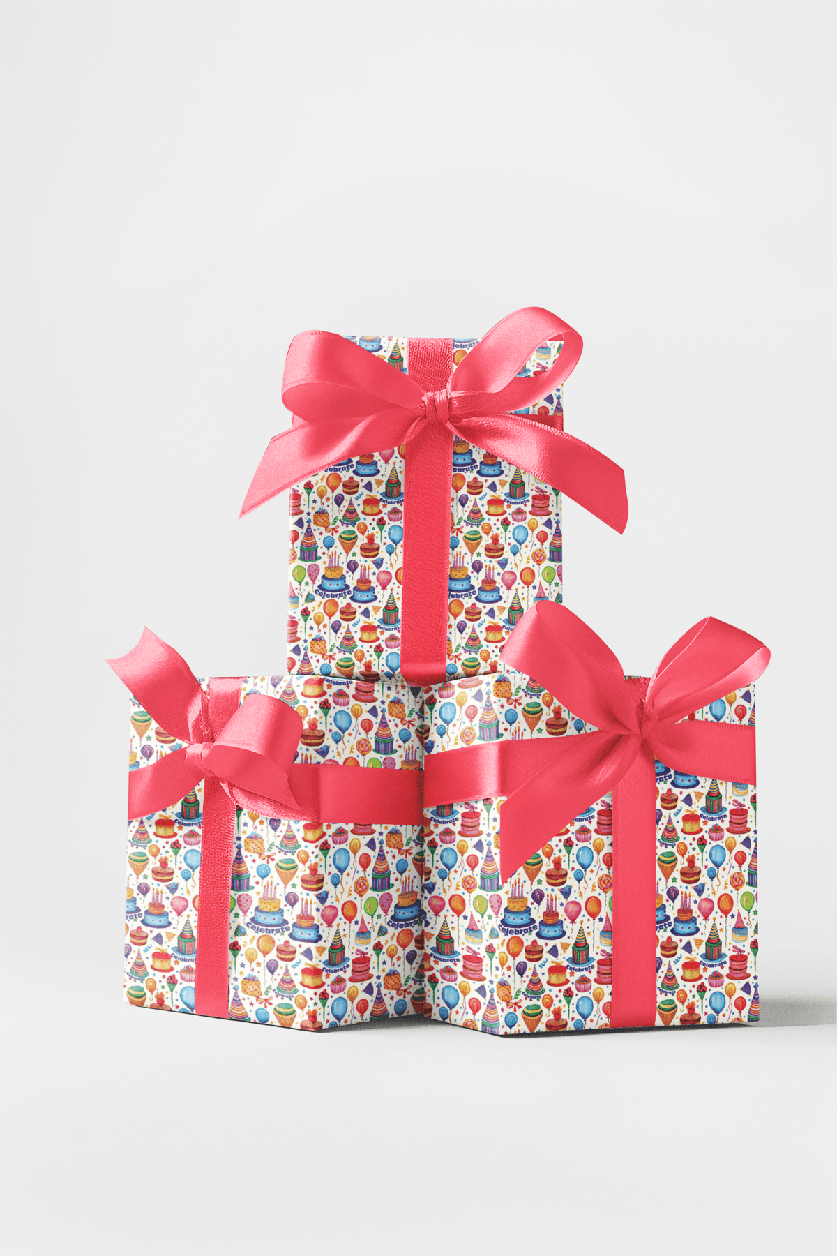 Birthday presents wrapped in cake-and-balloon paper with bright pink ribbons