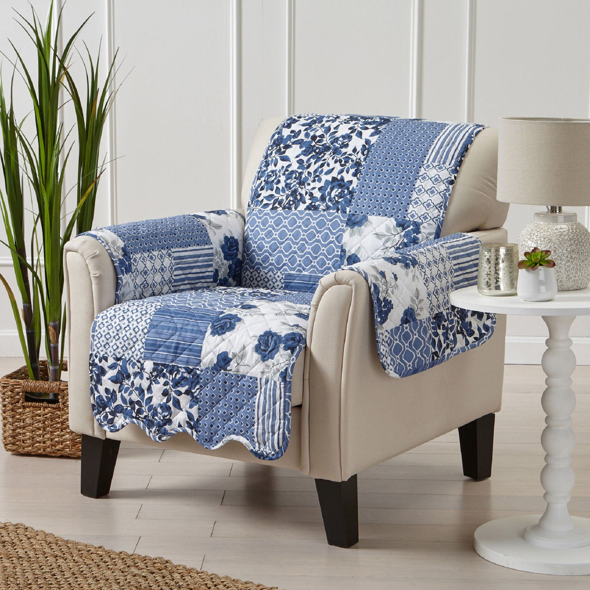 Reversible armchair protector in blue and white patchwork floral, draped over a beige chair.