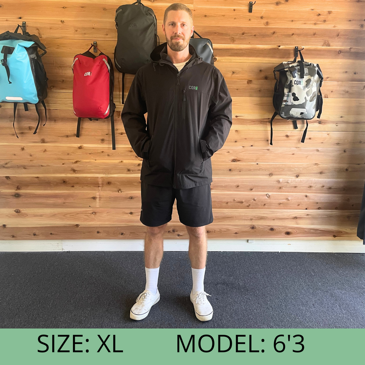 Black hooded rain jacket with full-zip front and zip pockets
