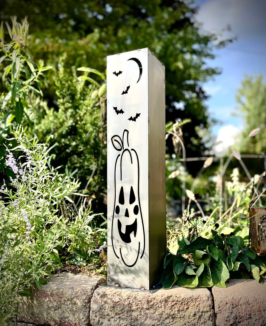 Steel solar pillar light with black bat moon graphic and jack-o-lantern face