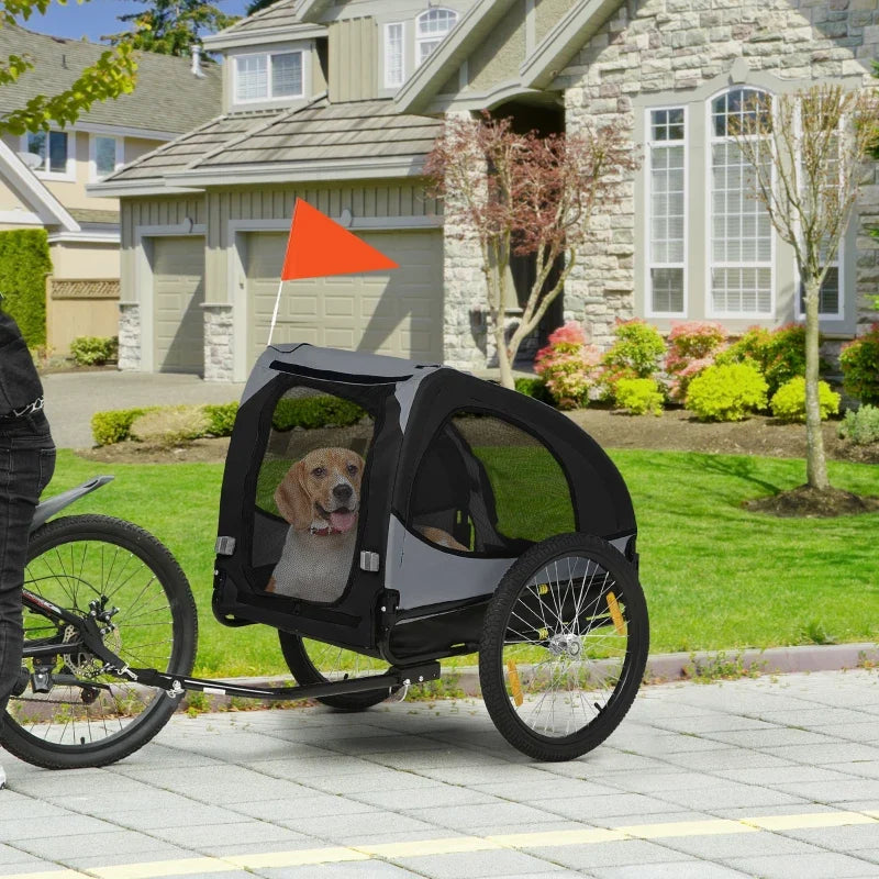 Black dog bike trailer stroller with mesh door and wheels, beagle dog inside