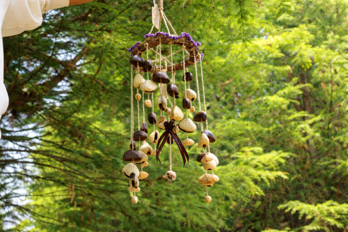 Hanging vine wreath seed chime with dark bells and beige seed pods