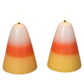 Two lit candy corn wax candles with white, orange, and yellow layers