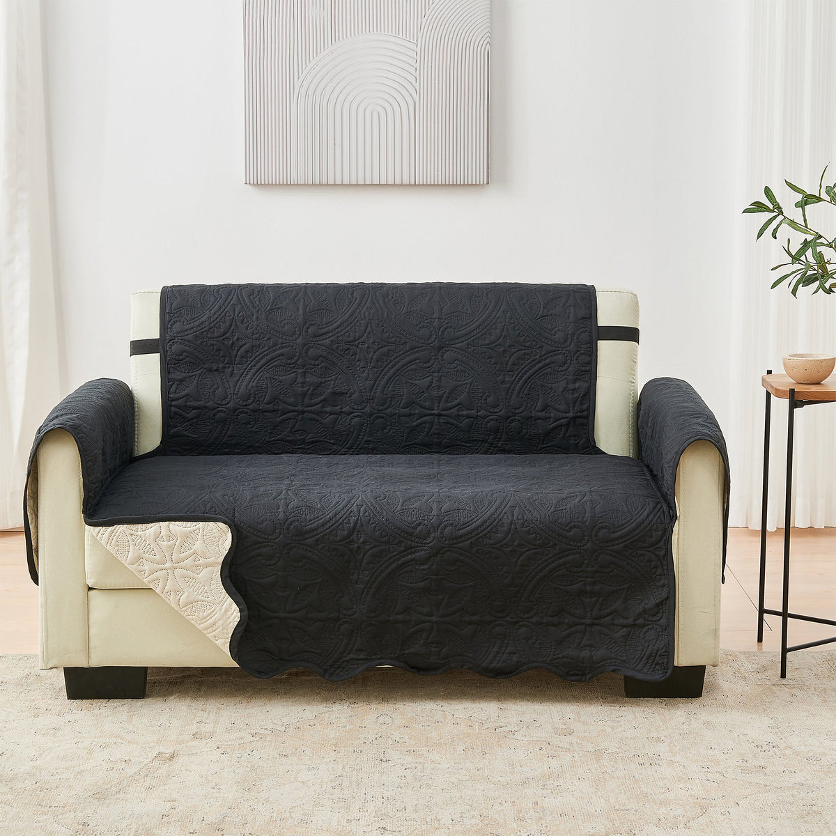 Sofa protector with dark quilted cover and light beige chair base sections, centered fold