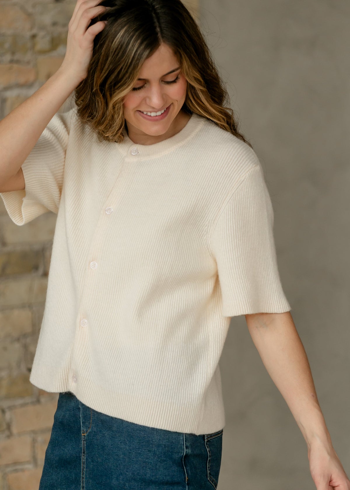 Ivory knit button cardigan with short sleeves and ribbed texture, crew neckline