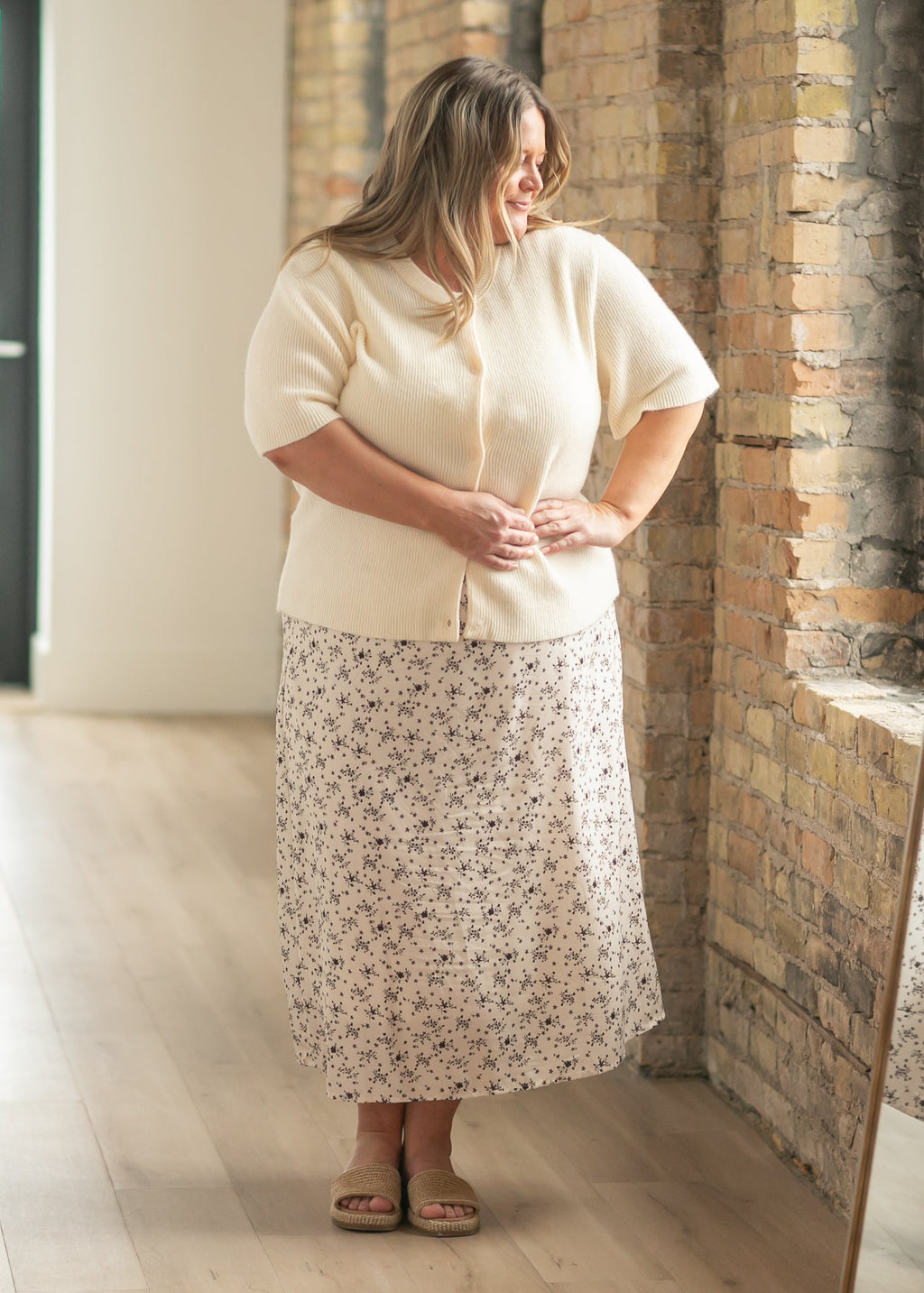 Ivory short-sleeve button cardigan with rounded neckline and textured knit