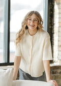 Ivory button-front short-sleeve cardigan, ribbed texture, V-style neckline