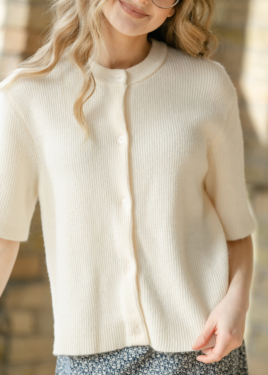 Ivory button-front short-sleeve cardigan detail with vertical ribbing