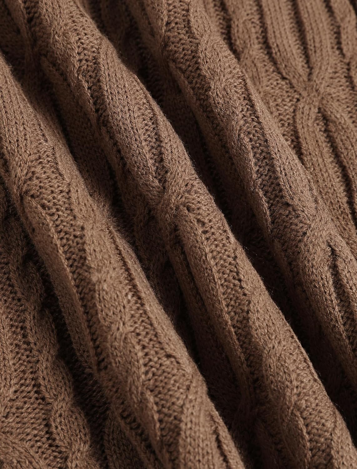 Close-up of brown cable knit texture on an oversized V-neck sweater
