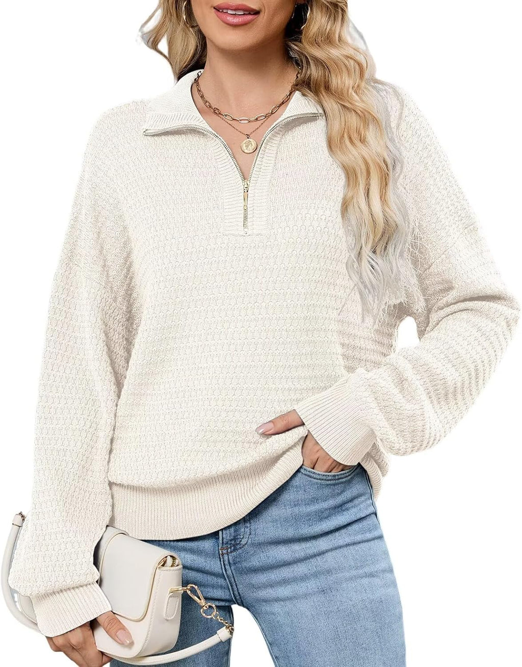 Off-white textured quarter-zip sweater with half-placket and ribbed cuffs on model.