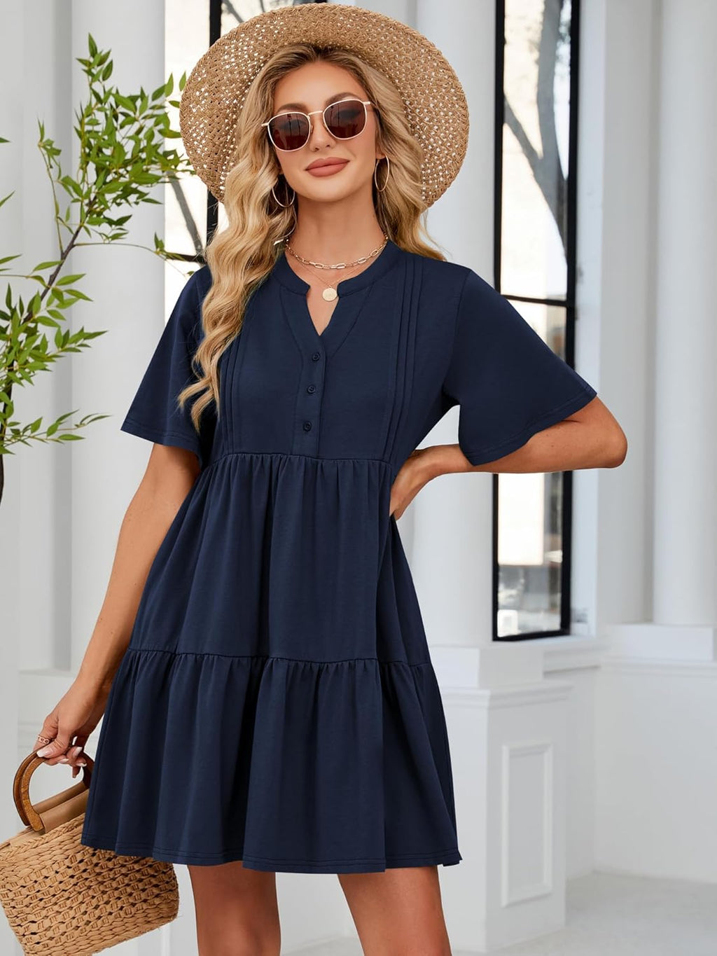 Navy blue V-neck button-front babydoll dress with tiered skirt and short flutter sleeves