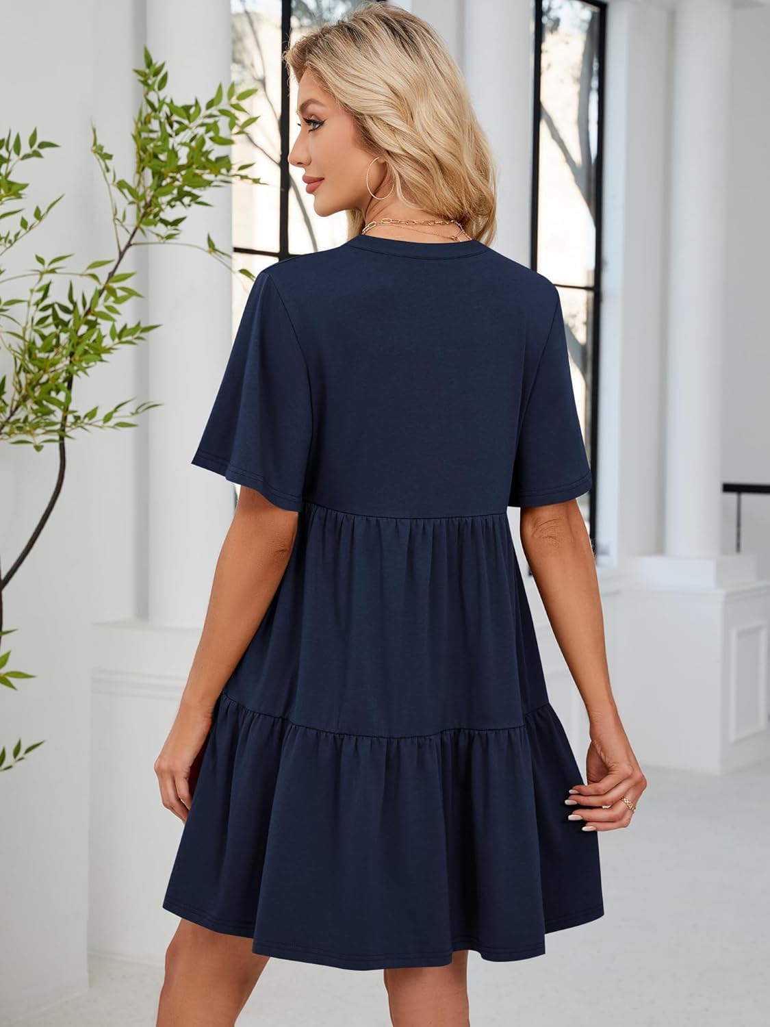 Navy blue babydoll dress back view with tiered skirt and short flutter sleeves