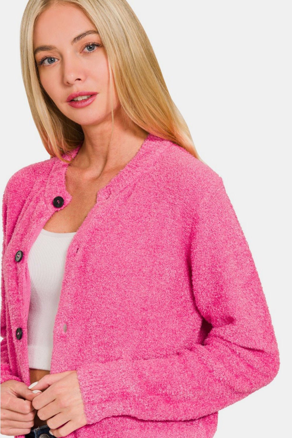 Fuchsia knit cardigan with button placket and long sleeves over light top